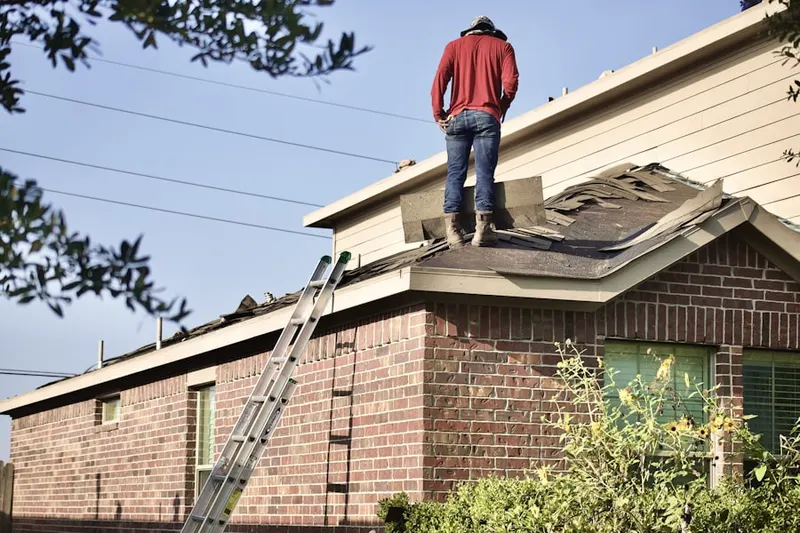 Professional roofer working on a residential roof in McQueeney